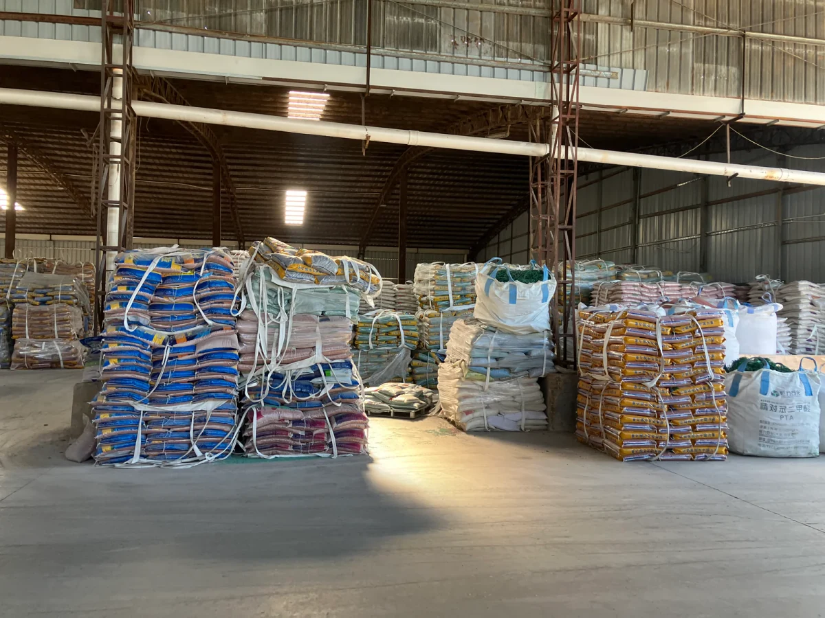 Organized warehouse stock of bagged EPDM granules prepared for order coordination