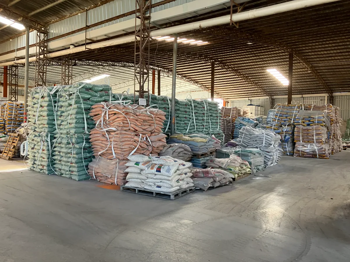 Prepared sports surfacing materials arranged in a warehouse area
